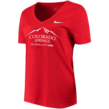 Load image into Gallery viewer, Red short sleeve v-neck t-shirt with white version of the city of Colorado Springs: Olympic City USA logo printed on front. White Nike logo under right shoulder. Team USA and Nike tags attached to right sleeve.