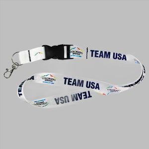White lanyard with a black detachable buckle decorated with with official City of Colorado Springs: Olympic City USA and Team USA logos and wordmarks