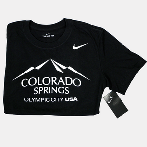 Folded in half black short sleeve T-shirt with a white version of the city of Colorado Springs: Olympic City USA logo screen printed onto it. White Nike logo printed underneath the shoulder.