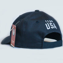 Load image into Gallery viewer, Back view of navy baseball hat. Team USA is embroidered above the closure of the hat.
