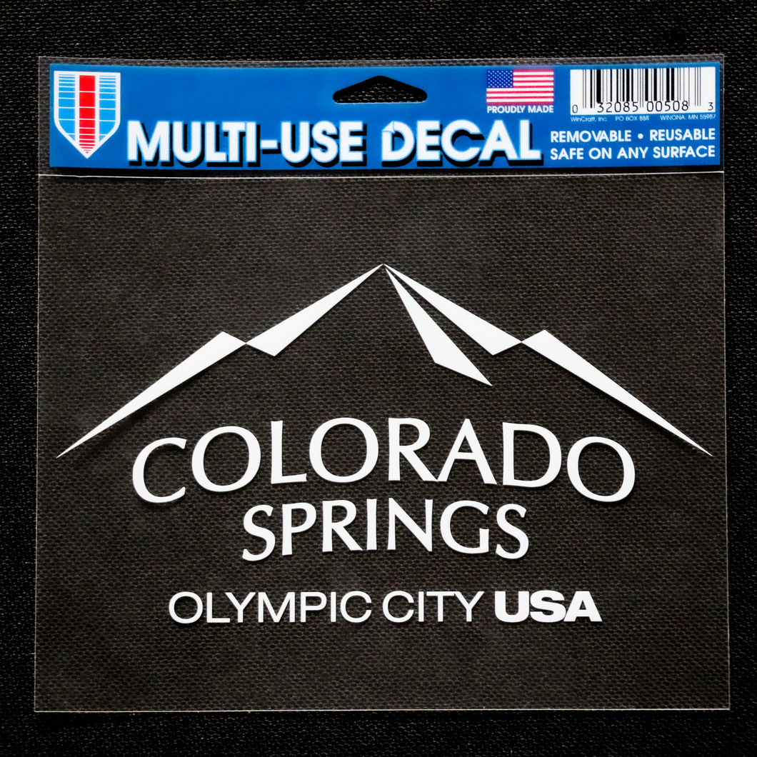 White-knockout city of Colorado Springs: Olympic City USA sticker inside of a clear plastic packaging.