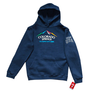 Navy pullover hoodie with hoodie pocket in front. Color version of the city of Colorado Springs: Olympic City USA logo printed in center. Team USA printed in white omn the upper right sleeve. Team USA tag attached to bottom of same sleeve.